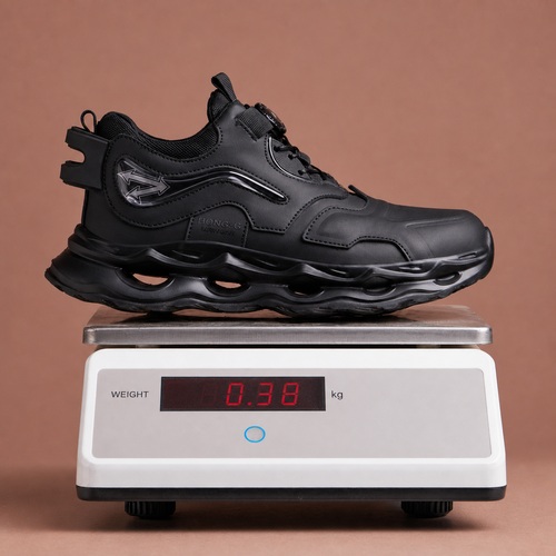 Lightweight black steel toe work shoe on a scale