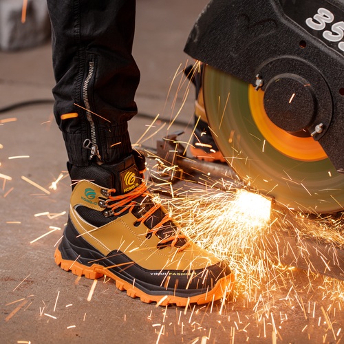 Steel toe welding work boots around grinding sparks