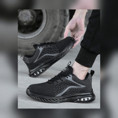 Black composite toe work shoes fully visible in an industrial setting