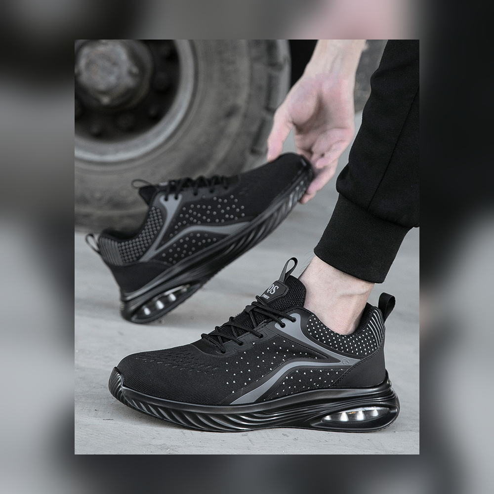 Black composite toe work shoes fully visible in an industrial setting