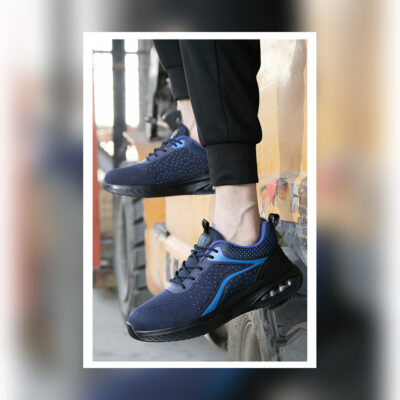 Navy/Blue work shoes fully visible in an industrial setting