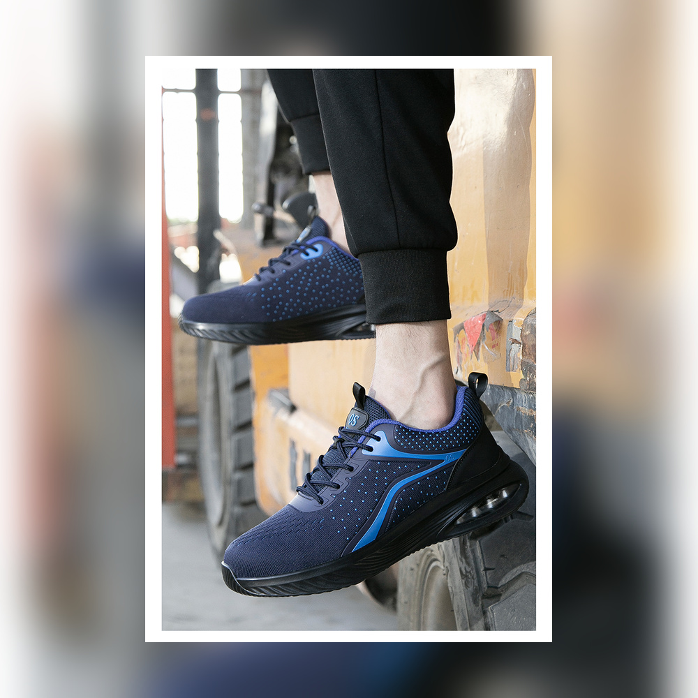 Navy/Blue work shoes fully visible in an industrial setting