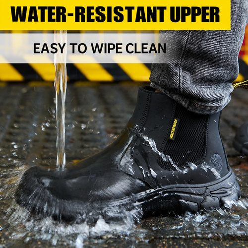 Water splashing over the upper of a black work boot