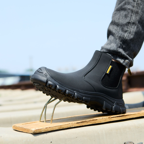 Work boot stepping over raised nails to show underfoot protection